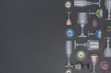 Pattern of wineglass and glass. Flat lay concept on a black background. Top view.