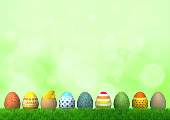 Neun bunte Ostereier mit Küken auf einer Wiese vor grünem Hintergrund
