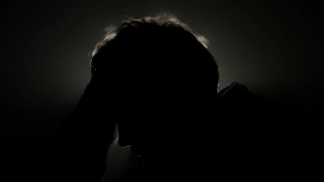 Crazy man scratching her head with black hair. Macro shot.
