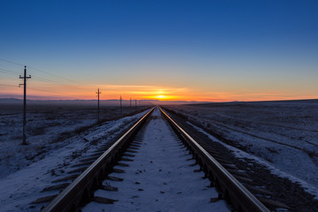 Railway receding into the distance at sunrise