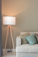 modern living room with green pillows on cozy sofa and wooden la