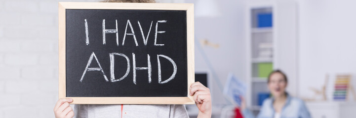 Kid holding a blackboard