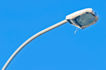 Street light with cable out isolated on sky.