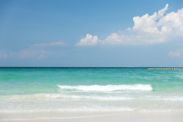 Beautiful gentle wave at the shallow beach with blue sky