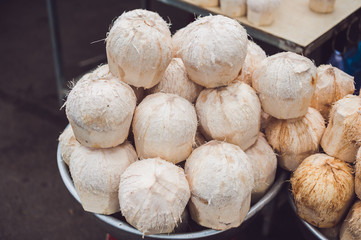 Coconuts in the Vietnamese market, typical street food business in Asia