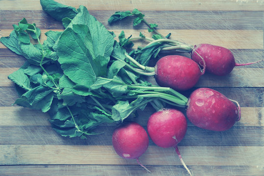 Red radishes on a cutting board