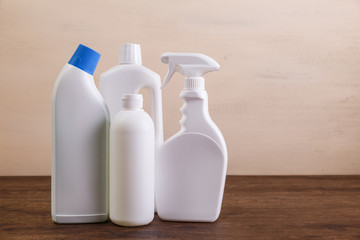 Mock-up plastic bottles. Cleaning products, washing wc cleaner. Mockup design for branding. Front view. Wooden rustic board.