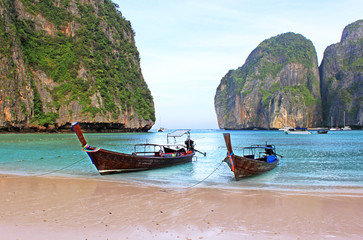 Fototapeta na wymiar Holiday vacation concept background - Long tail boat on tropical beach with limestone rock, Krabi, Thailand