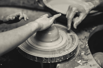 Close-up of female hands holding a clay