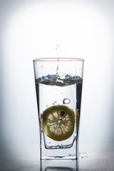 slice of lemon drops in a glass of water