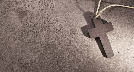Holy christian cross on stone background for funeral card.