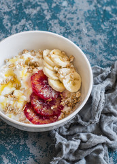 Breakfast bowl. Ricotta with honey, blood oranges, banana and crunchy oatmeal