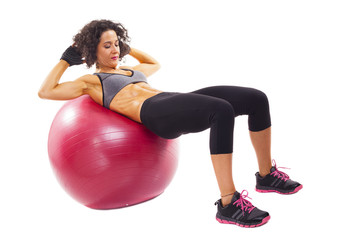 Young woman doing abs on a fit ball, isolated on white backgroun