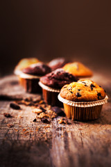 Chocolate muffins on wooden table, homemade bakery, close up ima