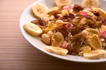 flakes with dried fruit, granola on the plate