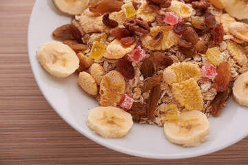 flakes with dried fruit, granola on the plate