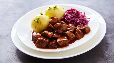 Two boiled potatoes and braised purple cabbage
