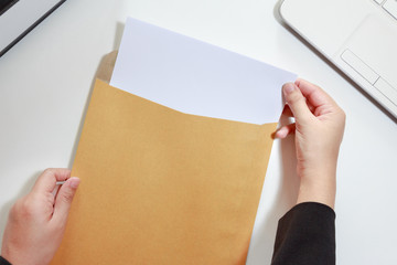Businesswoman hands holding the blank paper in envelope - business - obrazy, fototapety, plakaty