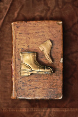 Vintage Book Cover with Brass Boots