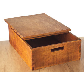 Open empty wooden box with a lid on the wooden table