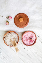 White and pink sea salt for spa on white wooden table