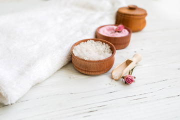 White and pink sea salt for spa on white wooden table