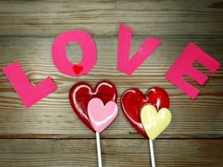 heart lollipops sweet love valentine's day on wooden background