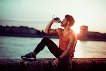 Man drinking water after a workout - obrazy, fototapety, plakaty