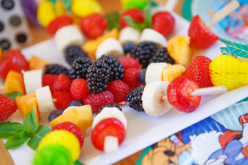 Canapes of fruits and berries at birthday party
