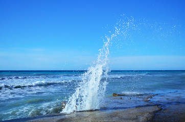Sea waves crashing against the concrete pier