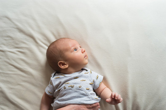 Cute Newborn Baby Boy Lying On Bed, Close Up