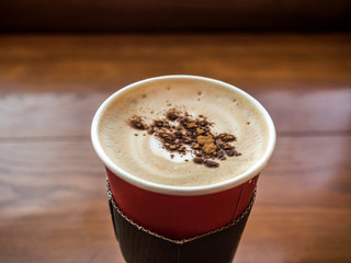 Coffee milk in paper cup on the table
