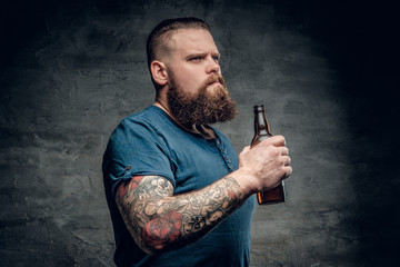 A man holds beer bottle.