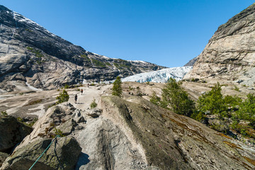 Fototapeta na wymiar People hiking to the Nigardsbreen glacier, Jostedalsbreen National Parkm, Norway. 