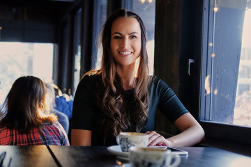 Brunette woman in a cafe.