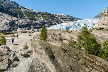 Fototapeta na wymiar People hiking to the Nigardsbreen glacier, Jostedalsbreen National Park, Norway. 