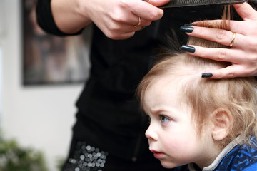 Fototapeta premium Child having a haircut first time
