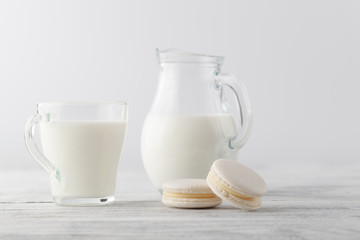 Jug of milk and cup with macaroons