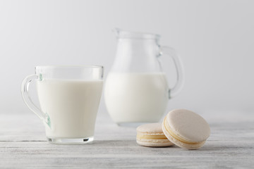 Jug of milk and cup with macaroons