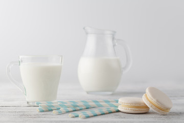 Kid breakfast with milk and white macaroons on table