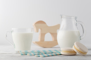 Jug of milk and cup with macaroons