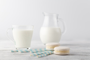 Kid breakfast with milk and white macaroons on table