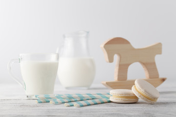 Kid breakfast with milk and white macaroons on table