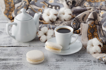 woman breakfast with shawl and white macaroons