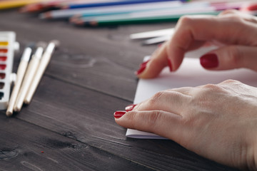 Woman do origami, bend paper sheet for do figure