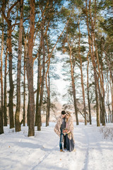 Fototapeta na wymiar Outdoor happy couple in love posing in cold winter weather. Young boy and girl having fun outdoor