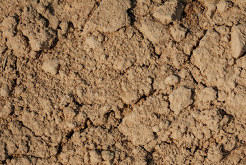the texture of the clay , the cracks on the surface of the earth , the background is yellow