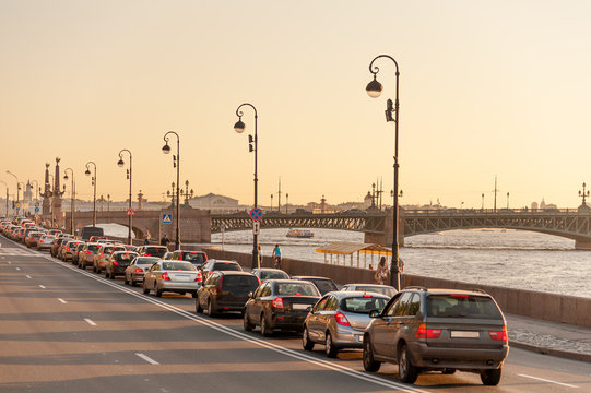 Evening traffic on Palace embankment and Trinity bridge in downtown Saint Petersburg
