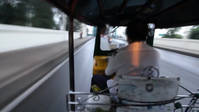 Time Lapse, Tuk Tuk driving on street in Bangkok, Thailand. A popular three-wheeled taxi transport in Bangkok.