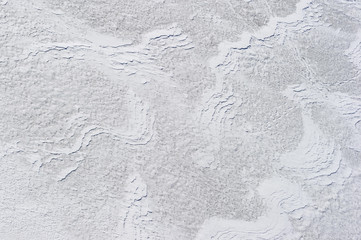 White textured background, snow surface wavy pattern created by winter wind, nature abstraction 